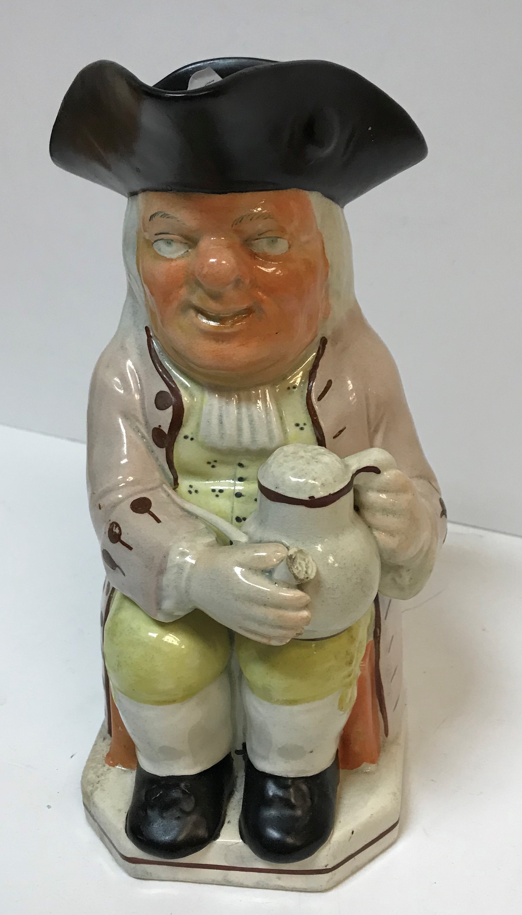 A 19th Century Staffordshire pottery Toby jug as "Toby Philpott seated with jug of ale on his left