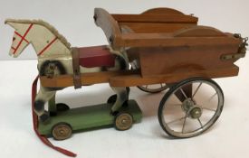 A circa 1930's painted wooden pull-along toy horse and cart, 35 cm long x 25.