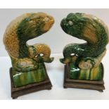 A pair of 19th Century Chinese Sancai yellow and green glazed pottery ridge tiles as stylised fish