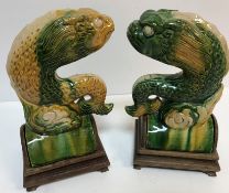 A pair of 19th Century Chinese Sancai yellow and green glazed pottery ridge tiles as stylised fish