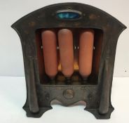 An Arts & Crafts copper electric fire with embossed decoration and set with Ruskin medallion to top
