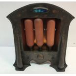 An Arts & Crafts copper electric fire with embossed decoration and set with Ruskin medallion to top