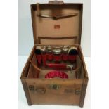 A circa 1900 leather cased gentleman's vanity and hat box containing various glass bottle and