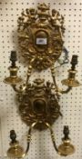 A pair of 20th Century gilt brass twin light wall sconces in the Rococo taste,