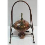 A circa 1900 copper spirit kettle in the manner of Christopher Dresser,