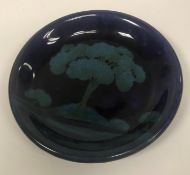 A Moorcroft moonlit pattern plate, with central tree decoration,