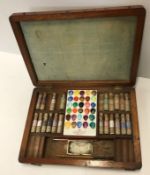 A mahogany cased artists paintbox containing various paints and porcelain plaque inside inscribed
