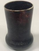 A Ruskin type high fired vase of elephant foot form in sang de boeuf colour 9 cm high