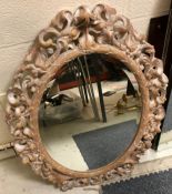 A modern oval wall mirror, the plate with bevelled edge,