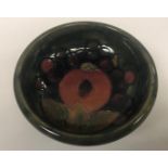 A Tudric Moorcroft pomegranate pattern pedestal bowl of small proportions the pewter base stamped