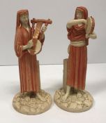 A pair of Royal Worcester James Hadley figures of musicians, one playing a tambourine,
