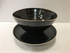 A Lucie Rie and Hans Coper black glazed elliptical bowl and saucer, both bearing both marks,