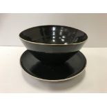 A Lucie Rie and Hans Coper black glazed elliptical bowl and saucer, both bearing both marks,