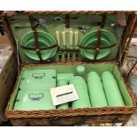 A vintage cane coracle picnic basket with Bandalasta and Thermos green plastic fittings
