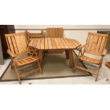 A modern slatted pine elongated octagonal garden table on splayed supports,