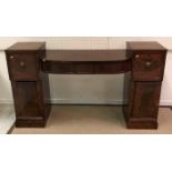 A Regency mahogany pedestal sideboard with central bow fronted three drawer section flanked by