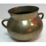 An 18th Century bronze twin handled cauldron of typical form 20 cm high