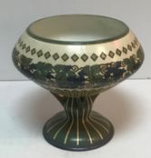 A large Mettlach pedestal bowl decorated with vines and grapes and scrolling decoration stamped