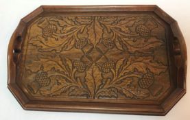 A wooden Arts & Crafts Scottish twin-handled tray with thistle decoration,