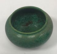 A Ruskin mottled green glazed vase of squat form stamped "Ruskin 1913" to base 9.