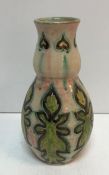 A Della Robbia stylised gourd shaped vase decorated by Cassandra (Cassie) Annie Walker with
