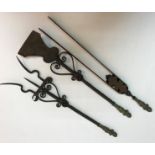 A set of three Continental wrought iron fire tools with brass putto handles comprising tongs,