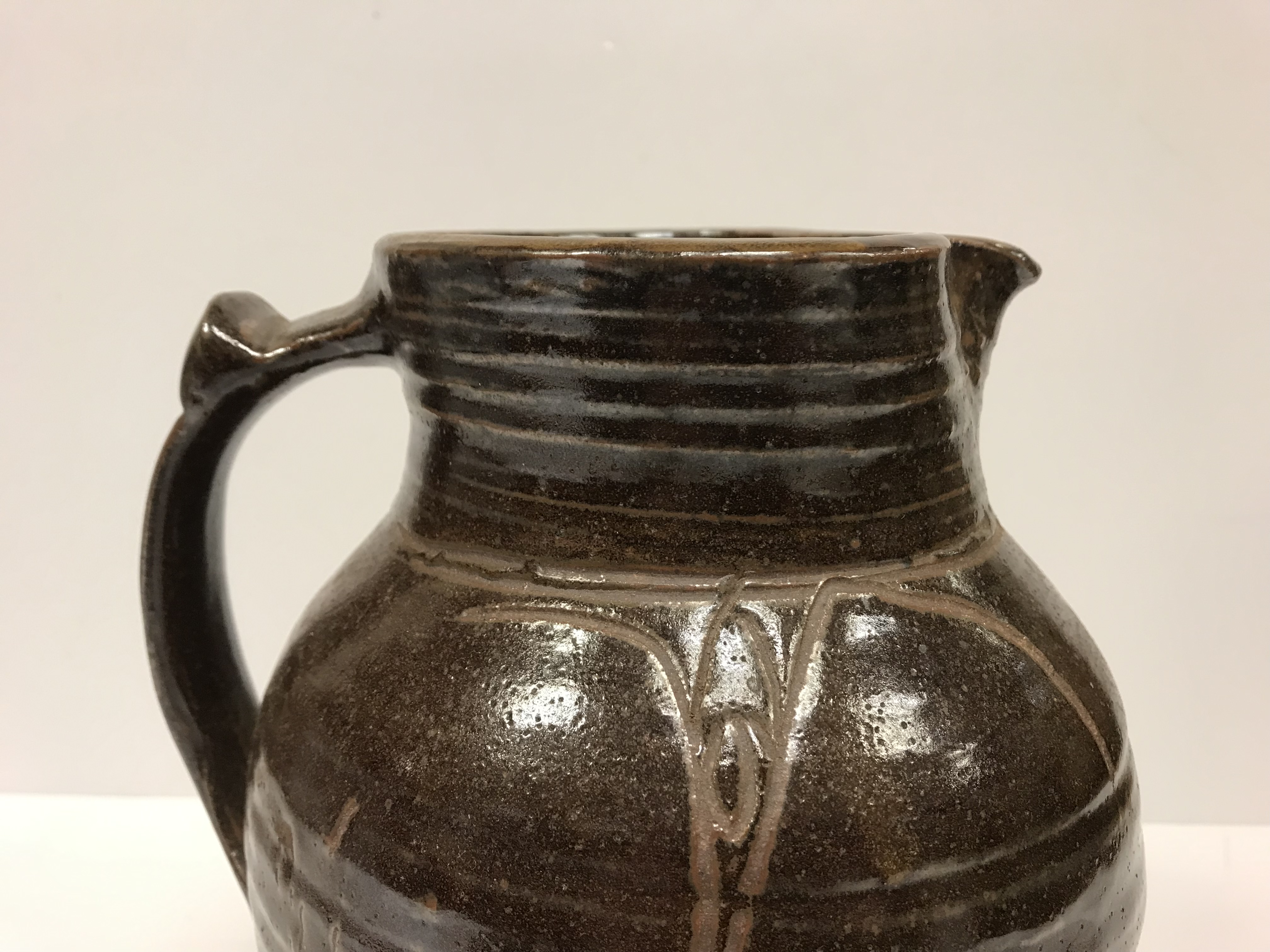 A Michael Cardew Wenfordbridge Pottery brown glazed ribbed jug with stylized floral spray - Image 3 of 22