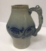 A Martin ware blue ground bellied jug with ram's head decorated handle,