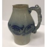 A Martin ware blue ground bellied jug with ram's head decorated handle,