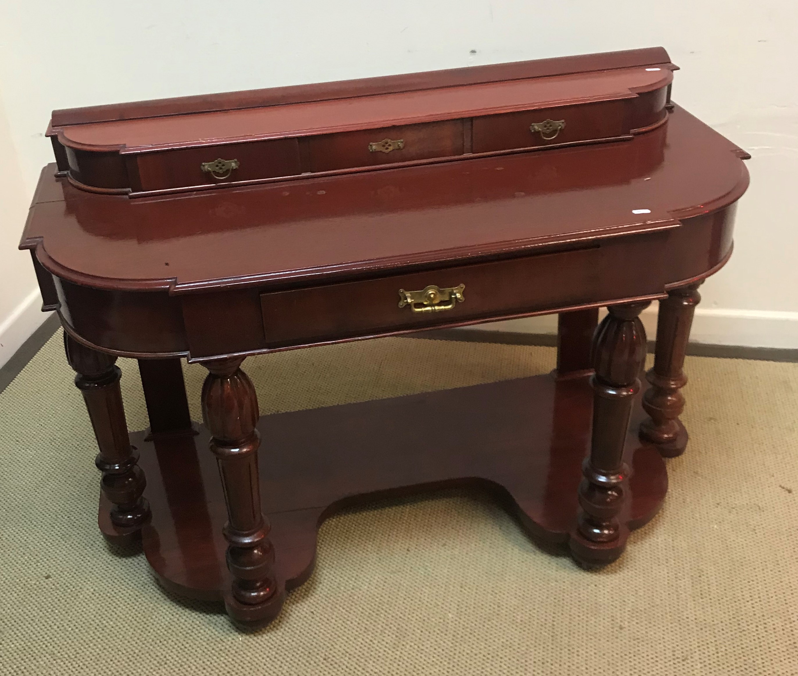 An Edwardian mahogany bow fronted side table with two slim drawers over two deep drawers raised on