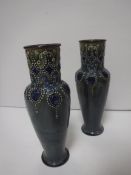 A pair of Royal Doulton relief work decorated vases, pale blue ground,