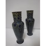 A pair of Royal Doulton relief work decorated vases, pale blue ground,