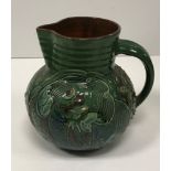 A C H Brannam Barum ware jug with incised stylised fish decoration on a green ground inscribed to