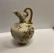 A Royal Worcester blushware pear shaped ewer with floral spray decoration raised on a circular foot