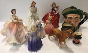 A collection of Royal Doulton figures and character jugs to include "Autumn Breezes", "The Polka",