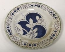 A Clarice Cliff “Bizarre” plate with floral spray decoration,