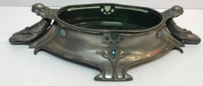 An Art Nouveau pewter table centre bowl with figural decoration and Ruskin style turquoise inset