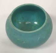 A Ruskin bowl shaped vase of pale blue and green colour way with incised decoration to the border