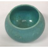 A Ruskin bowl shaped vase of pale blue and green colour way with incised decoration to the border