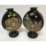 A pair of Victorian black glass vases with enamelled decoration depicting dead birds besides egg