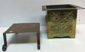 A circa 1900 Arts & Crafts brass jardiniere of square form with embossed stylised foliate and love