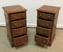 A pair of good quality walnut and feather banded four drawer bedside chests in the Georgian style