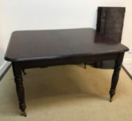 A mahogany extending dining table in the Victorian manner,