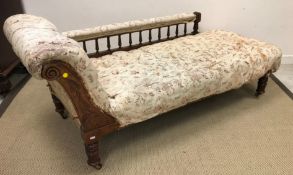 A late Victorian walnut framed chaise longue with galleried back rail on turned legs to casters 180