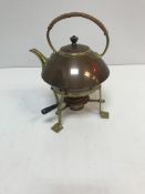A copper and brass kettle on stand in the Arts & Crafts manner,
