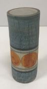 A Troika cylindrical vase with painted circular orange decoration on a blue ground signed "Troika