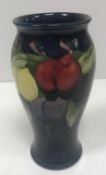 A Moorcroft wisteria plum pattern baluster vase signed and stamped "Moorcroft" to base together