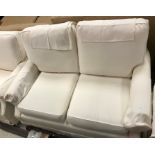 A Wesley Barrell cream ground two seat scroll arm sofa,