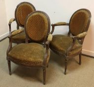 A set of three 19th Century French stained beech framed salon elbow chairs,
