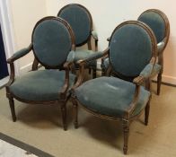 A set of four stained beech framed elbow chairs in the Louis XV taste with upholstered spoon backs